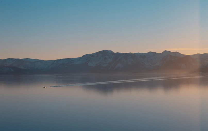 some mountains near the water with water vapor