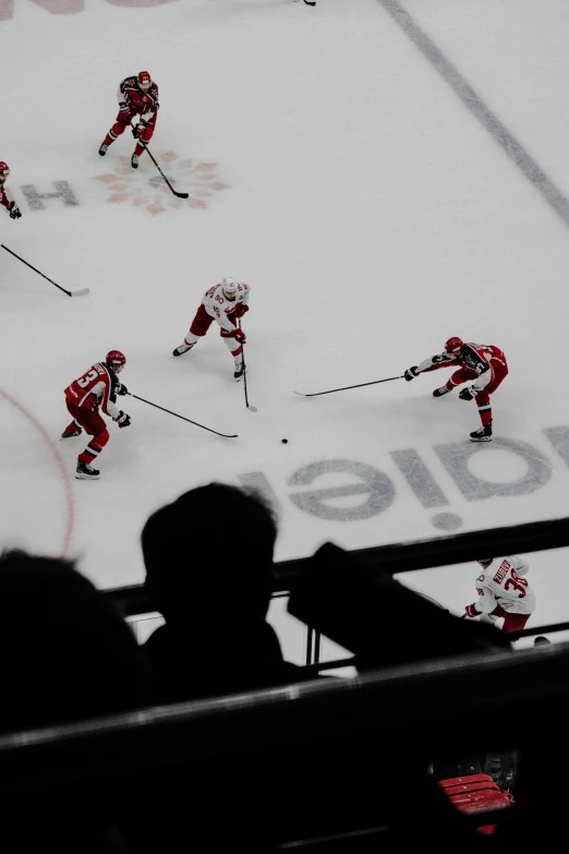 several teams of hockey players playing on the ice