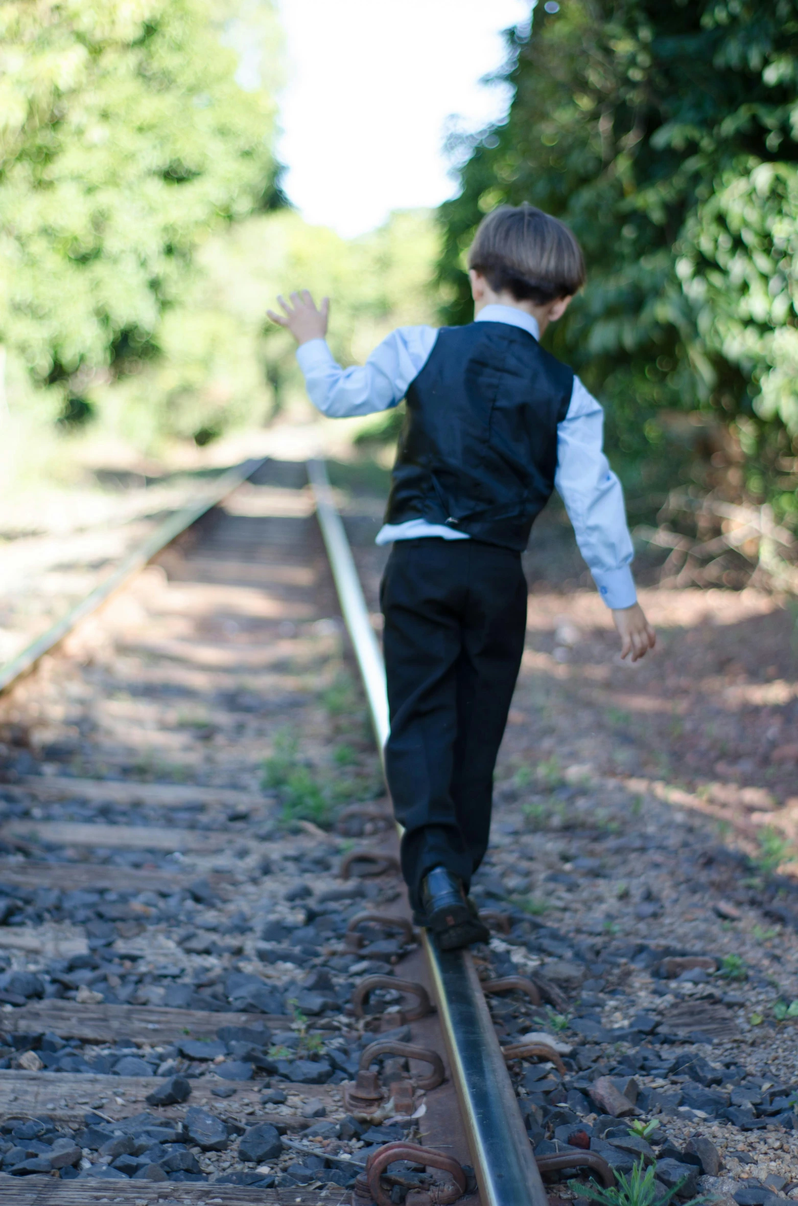 the  is playing on the railroad tracks