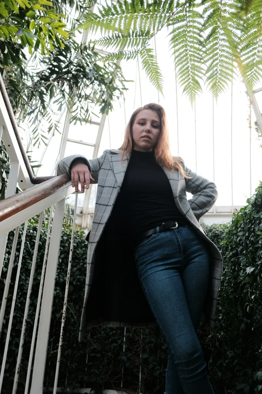 the woman is posing for the camera at the bottom of stairs