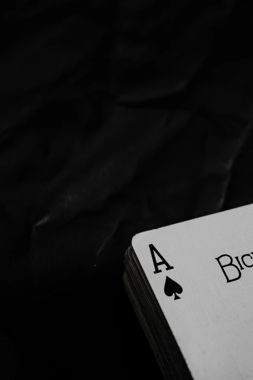 black playing card with the words a and a six on it