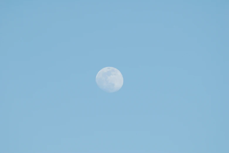 a plane flying in the air by a clear sky