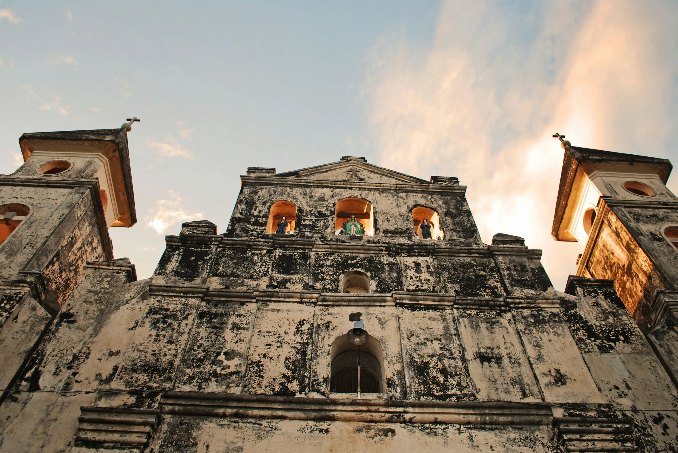 an ornate building has many windows and bells