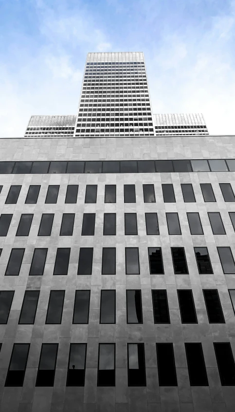 a tall, gray building with multiple squares on the side