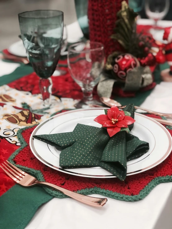 a christmas table is set with red and green napkins