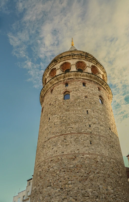 a very tall brick building with a clock at the top