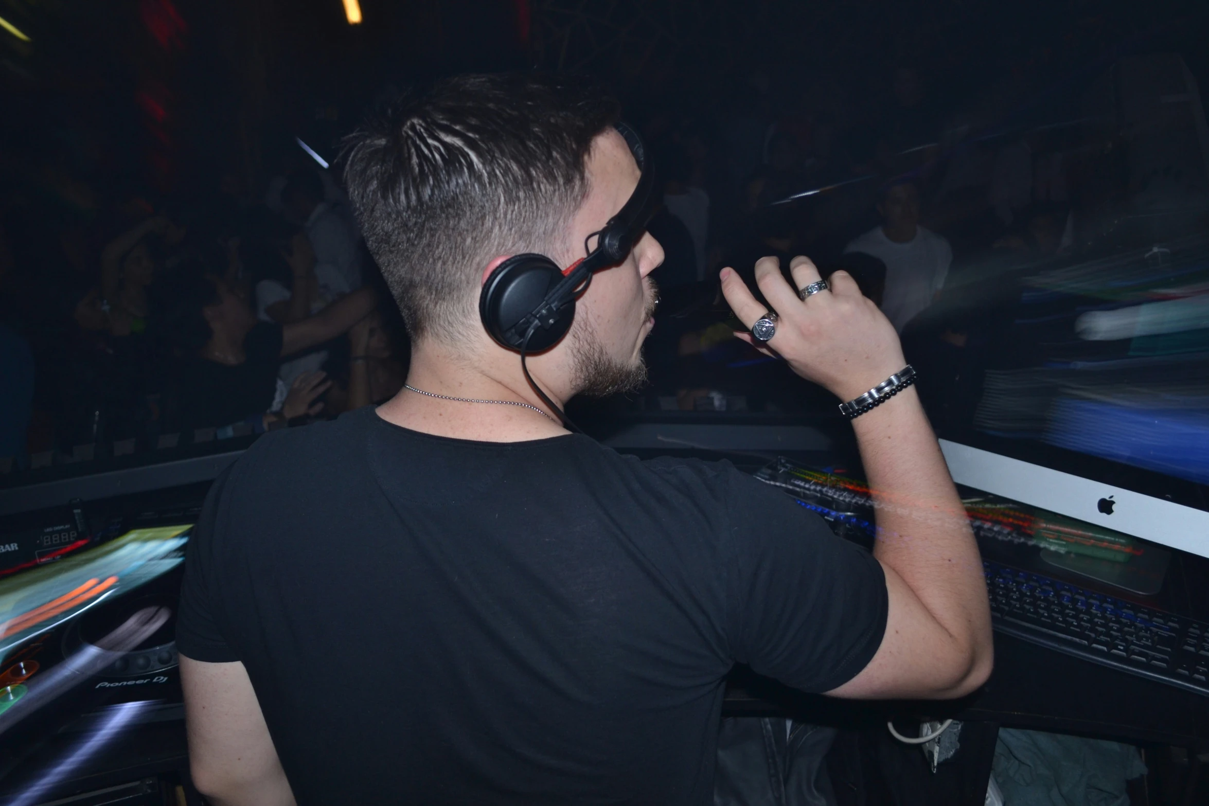 a man standing in front of a dj mixing