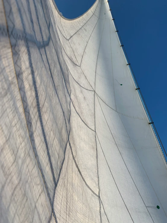 an image of sails that are being seen against the sky