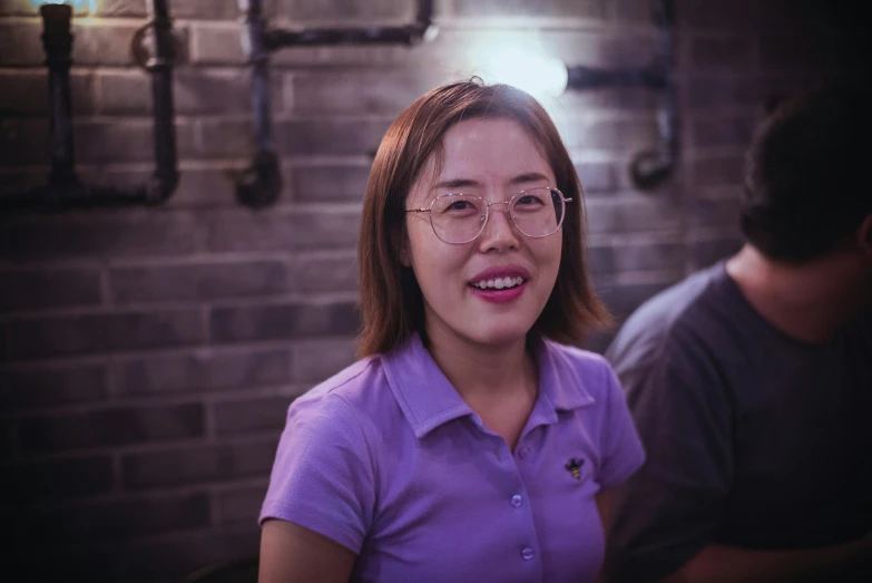 a woman is smiling and wearing a shirt