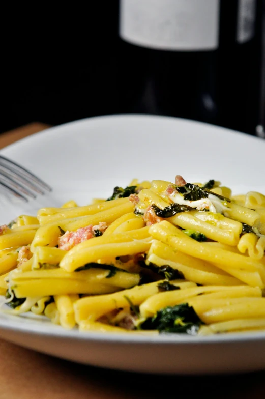 a plate full of pasta, broccoli and ham