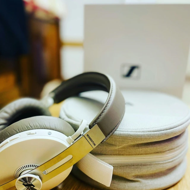 headphones sitting on top of a pile of white sheets