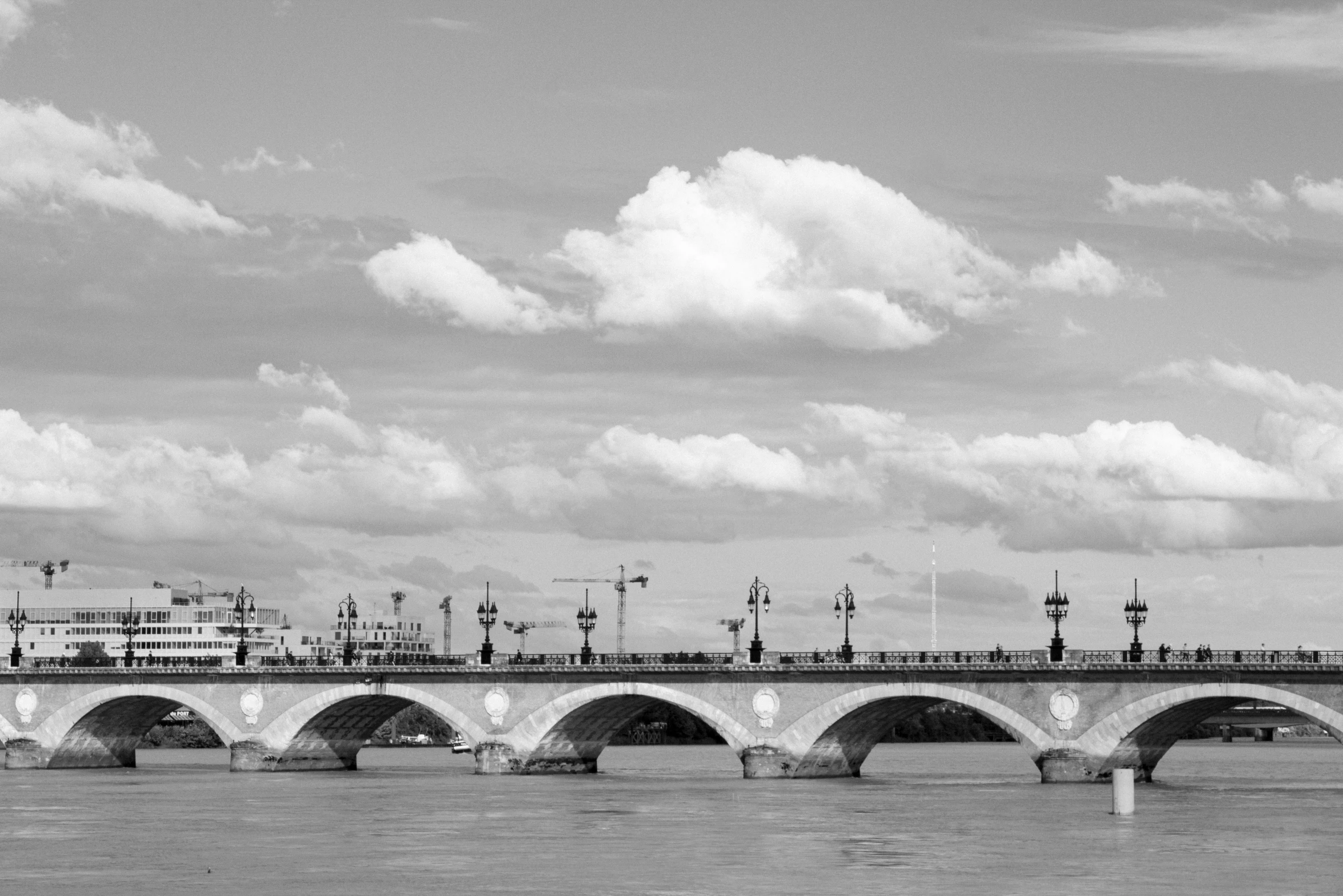 black and white pograph of bridge over water