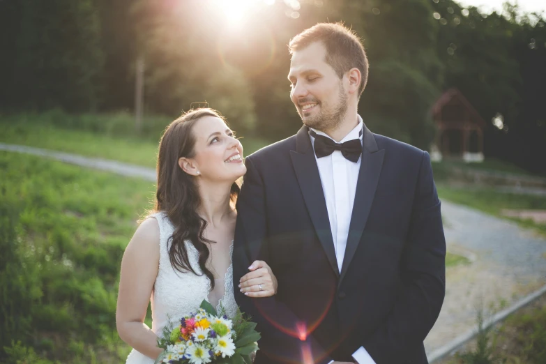 a newly married couple are standing by the road