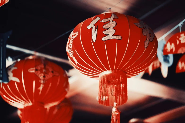 red lanterns are hanging from a ceiling