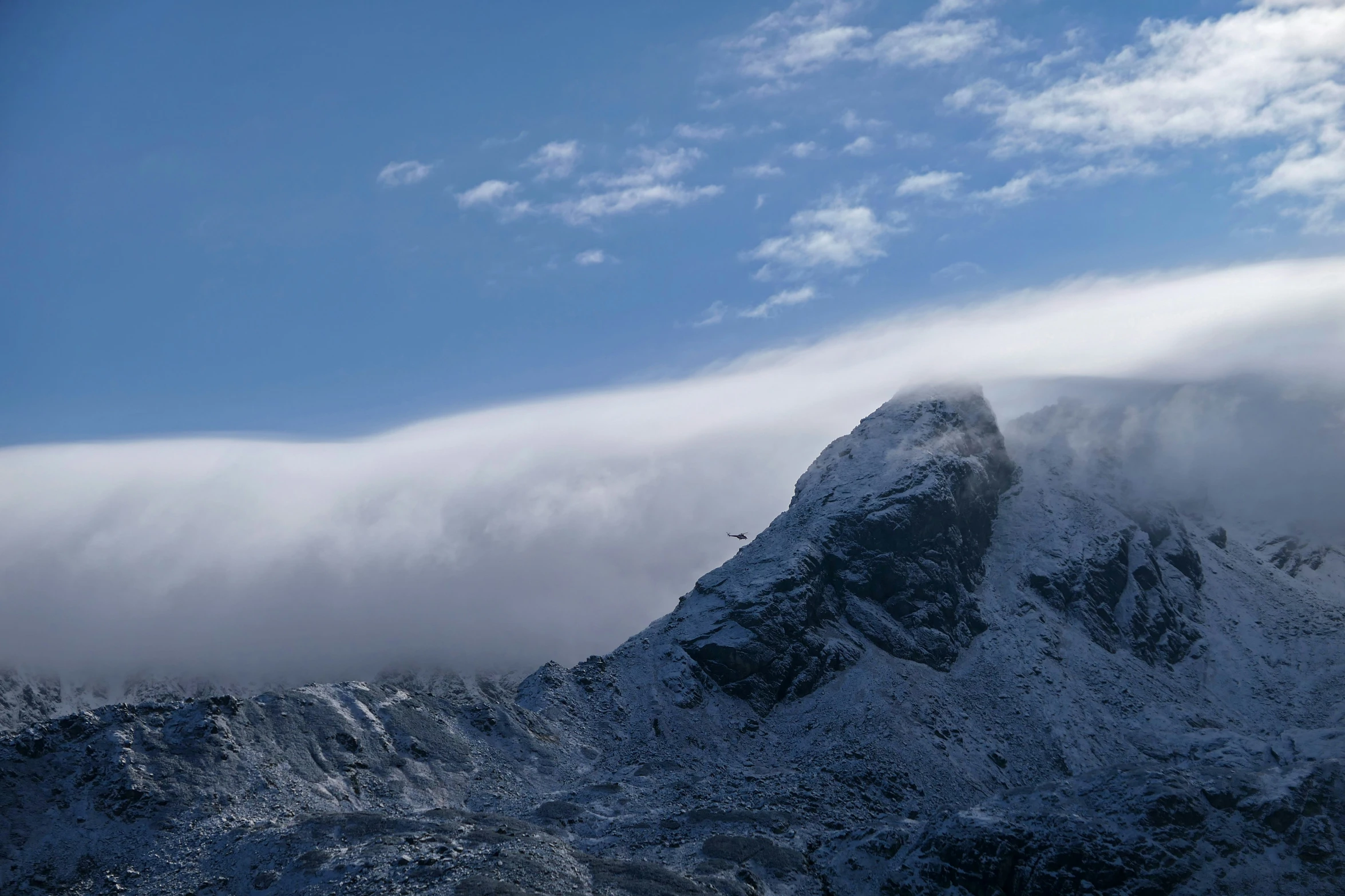 an almost empty mountain is covered in clouds