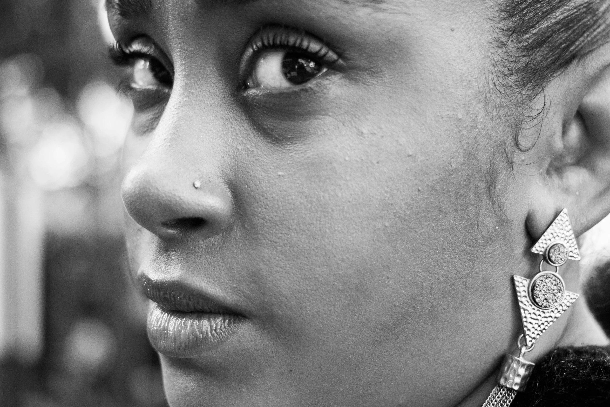 a close up of a woman's face wearing earrings