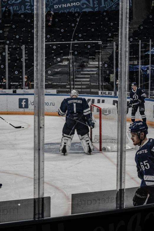 an ice hockey goalie gets ready to take a swing