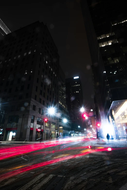 a large city street with lots of buildings at night