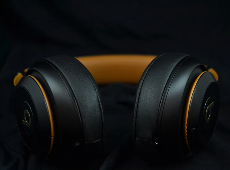 closeup image of a pair of headphones in black and yellow