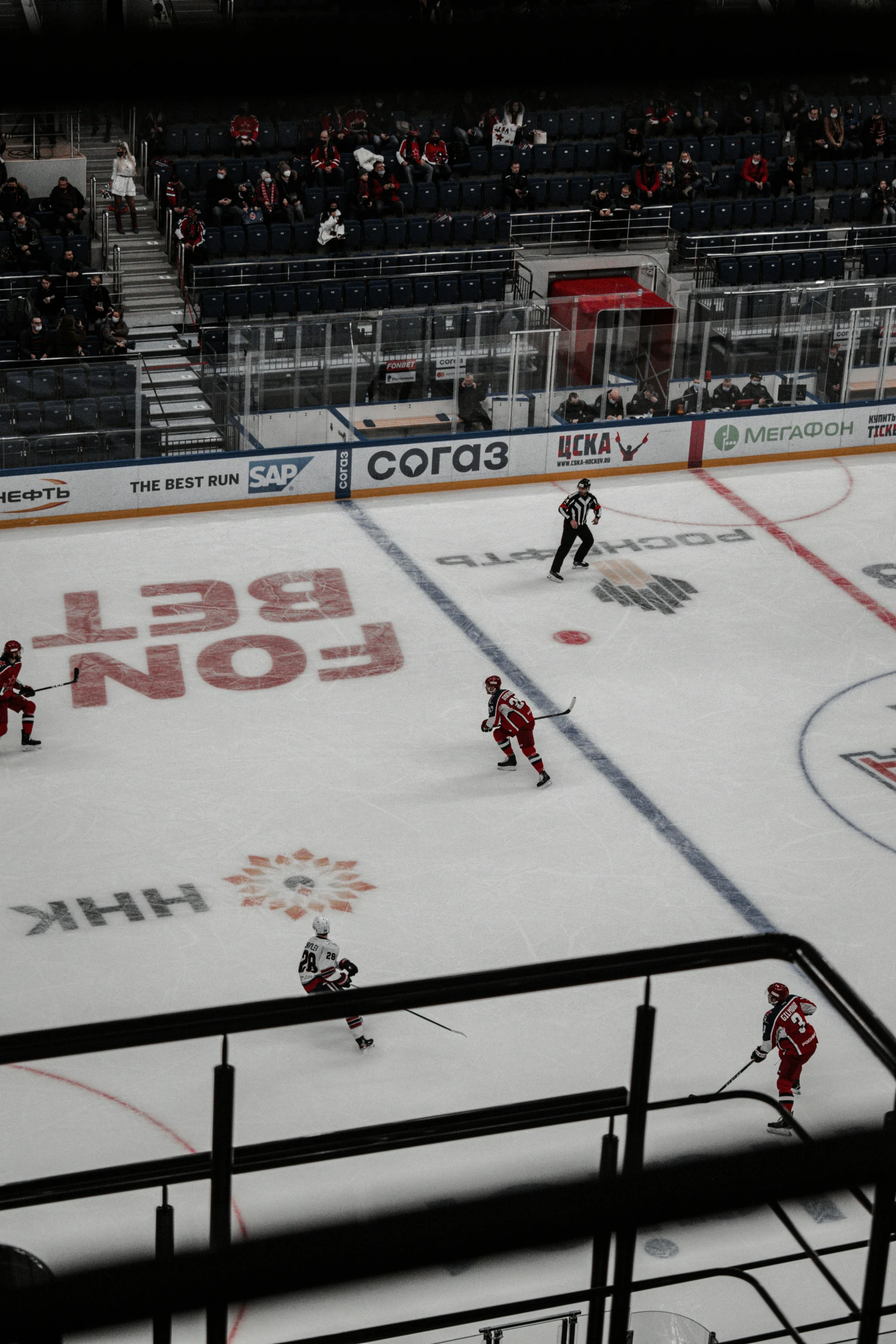 two teams playing hockey on an ice rink