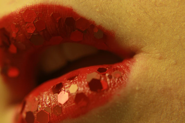 a close up of a person's lips, with glitter on it