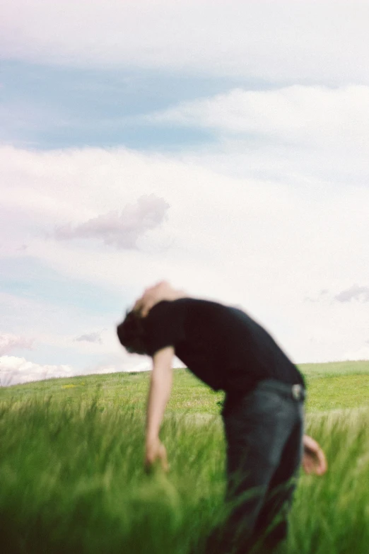 a person in a field with a kite