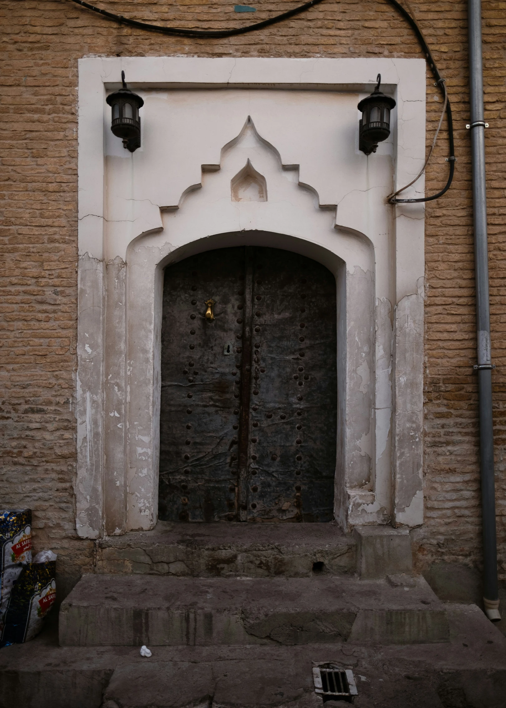 an old building with doors and pillars outside