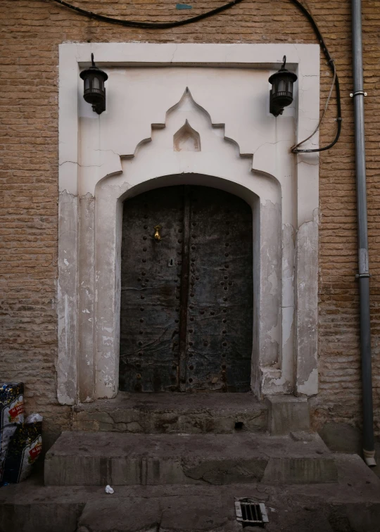 an old building with doors and pillars outside