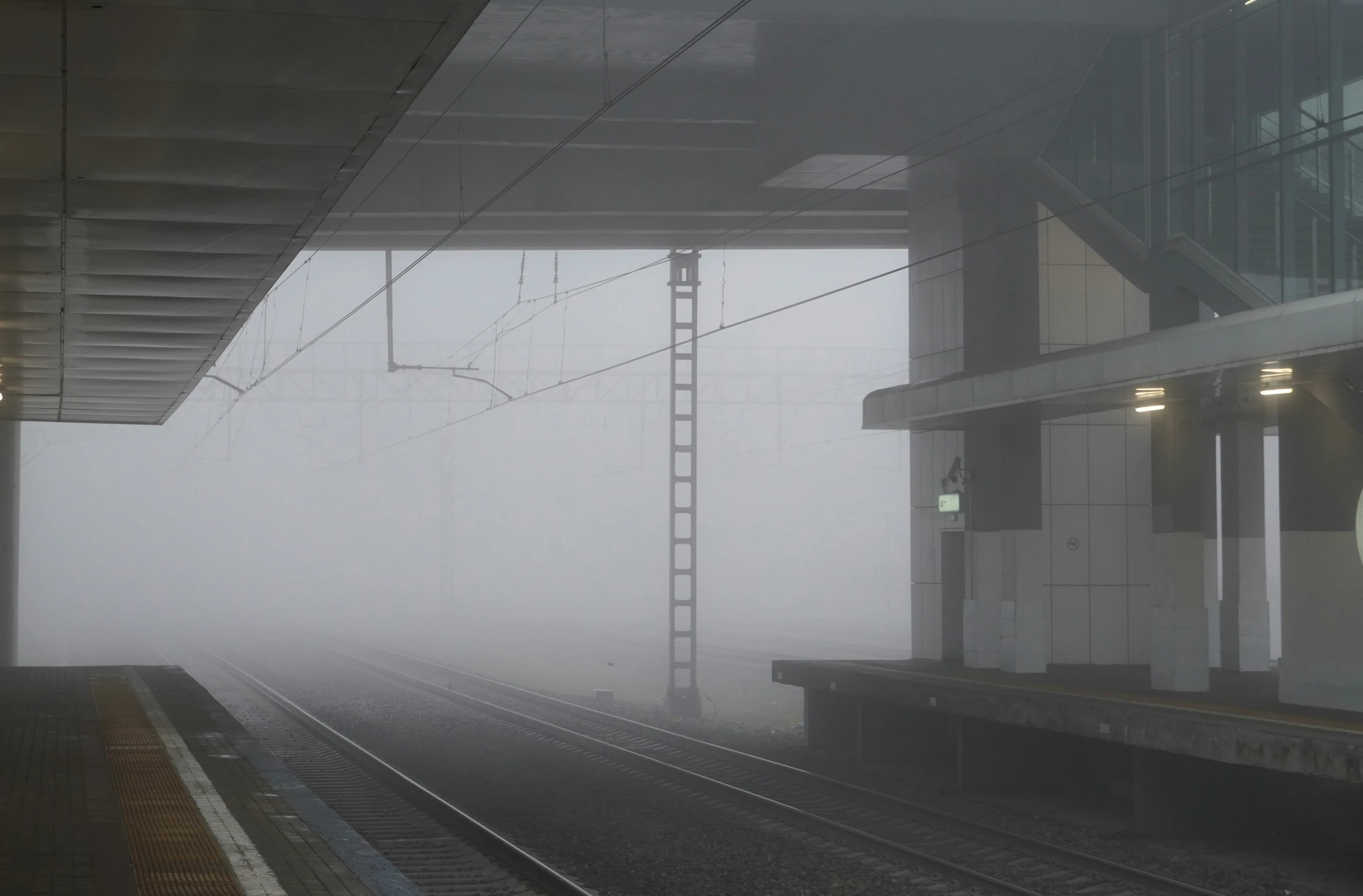 train tracks on a foggy day in the middle of nowhere