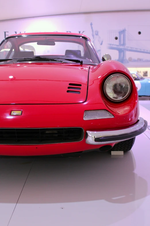 a red sports car sits inside a garage