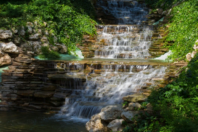 a small waterfall that is close to some trees