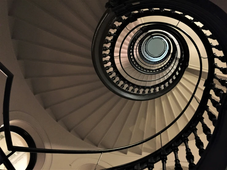 there are four white spiral stairs in a building