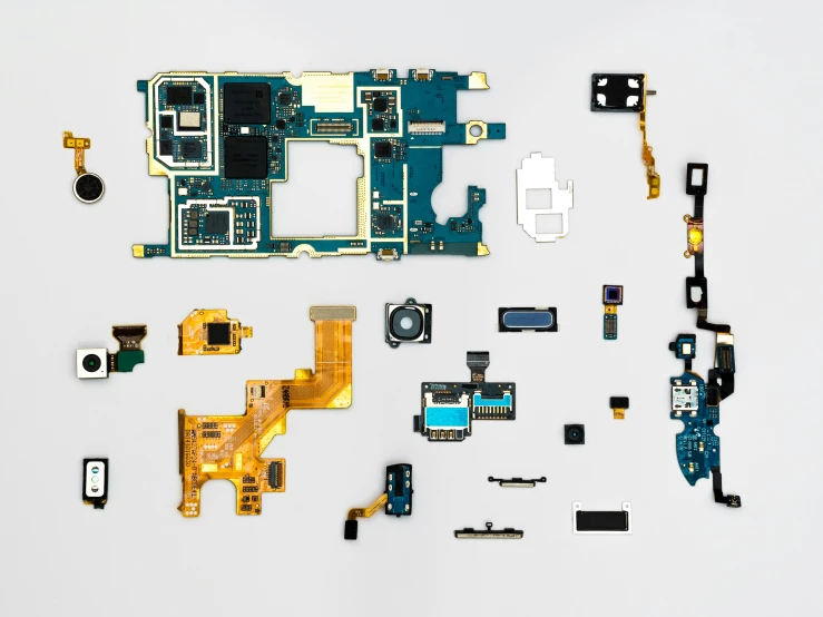 part of a circuit board, wires and components laying on the floor