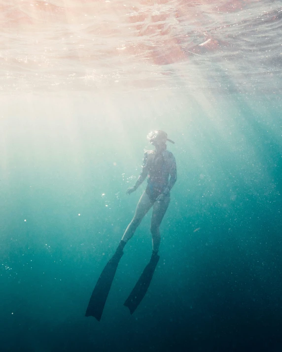 a man in the ocean with an object in his hand