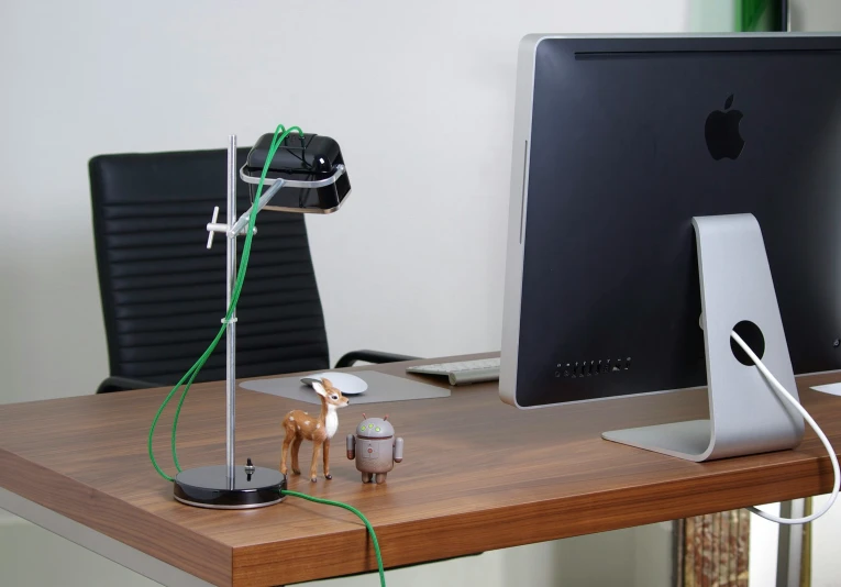 a desk with a computer monitor and keyboard