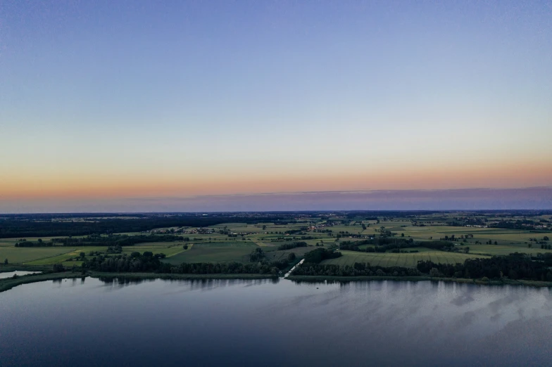 an image from above of a lake with a few trees