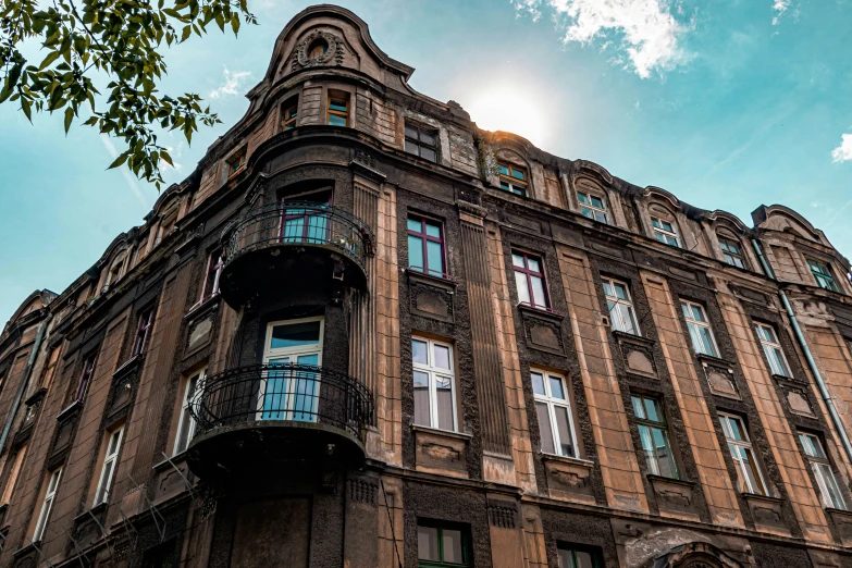 a building with windows and balconies is shown under a blue sky