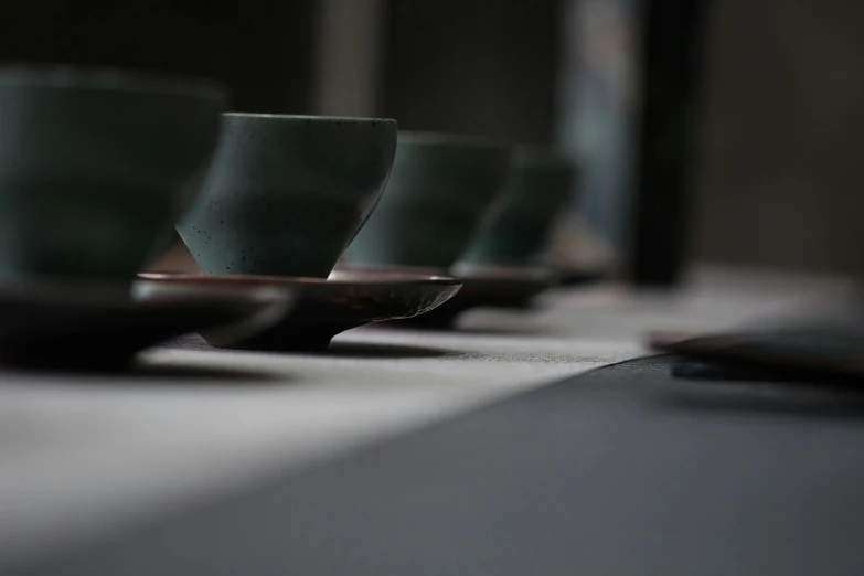 coffee cups lined up on a table next to each other