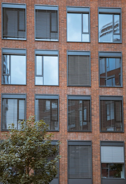an apartment building with several windows and large window blinds