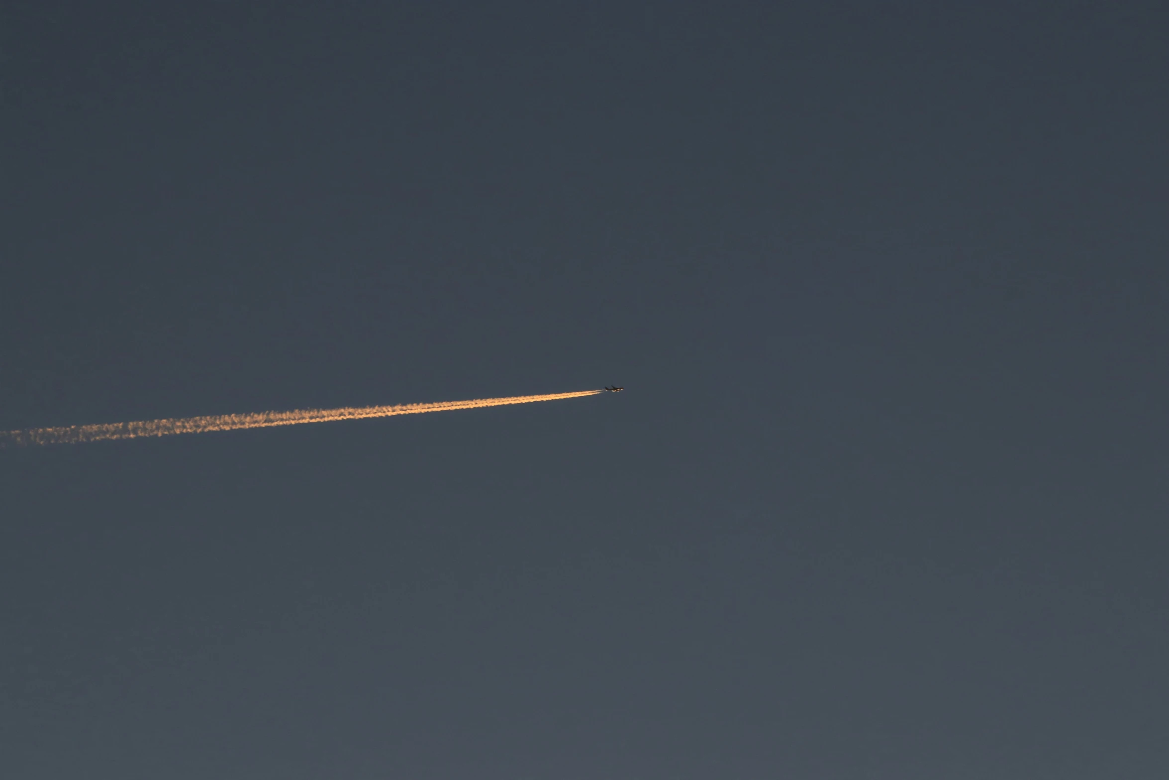 a small plane flies across the sky