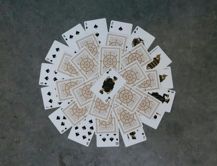 many playing cards are on the floor together