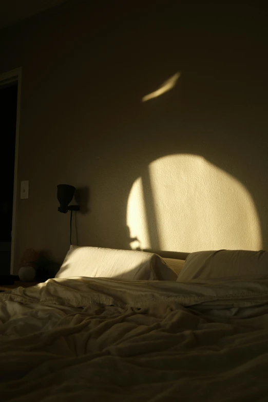 a bed is shown in a dimly lit room