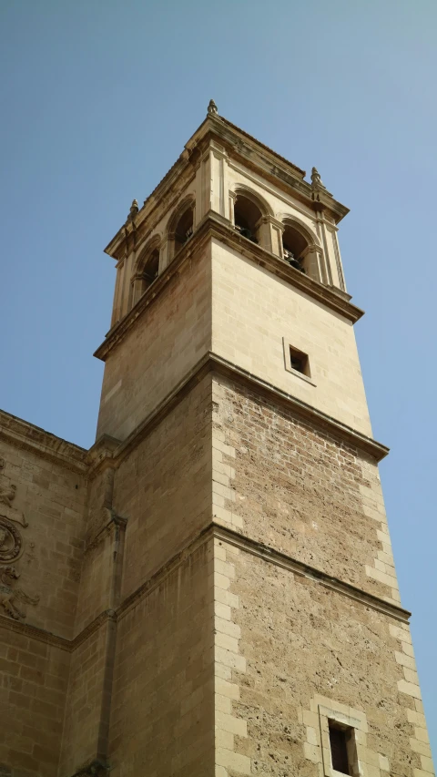 a large stone building with a clock at the top