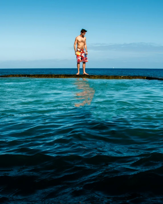 a man standing on the edge of the water