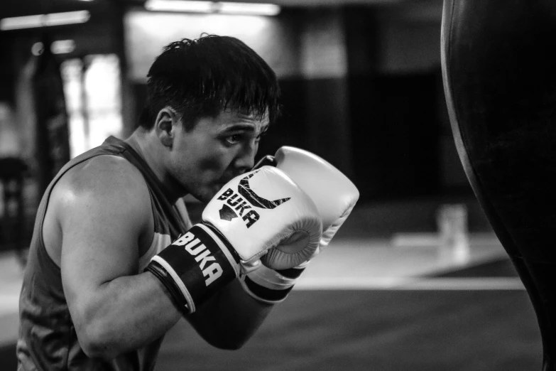 a man is wearing white gloves and has his hands to his face