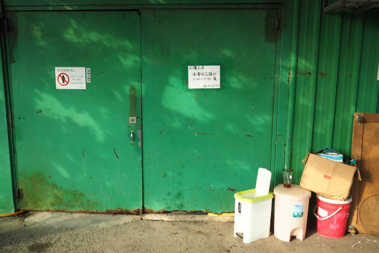 three jugs and a box on a sidewalk