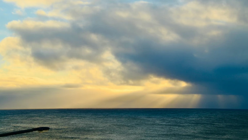 a large body of water under a cloudy sky