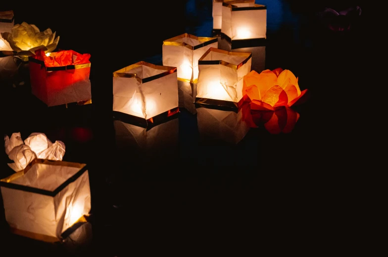 lantern - like items made of paper are shown in dark