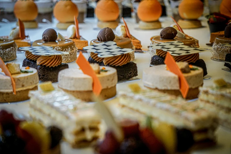 a table topped with lots of small cakes