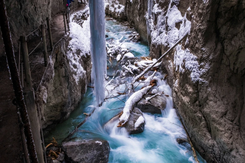 a mountain stream flowing through a mountain side